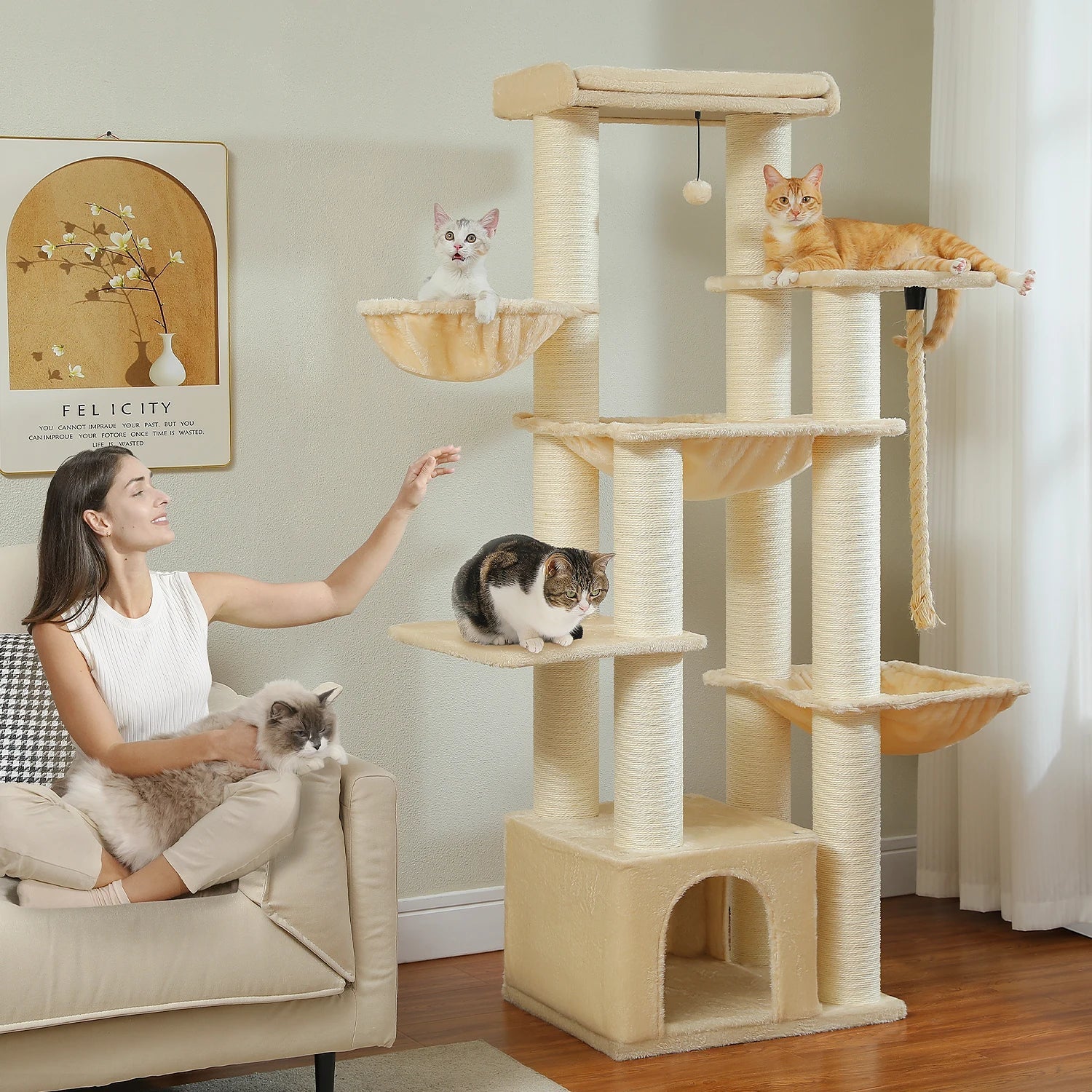 Woman interacting with cats on a multi-level cat tree in a living room.